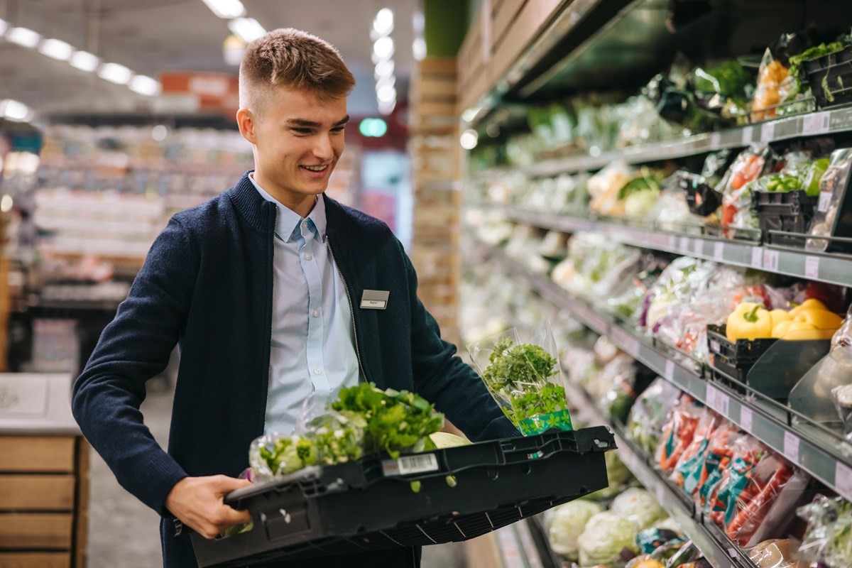 Supermarket worker, packing shelves